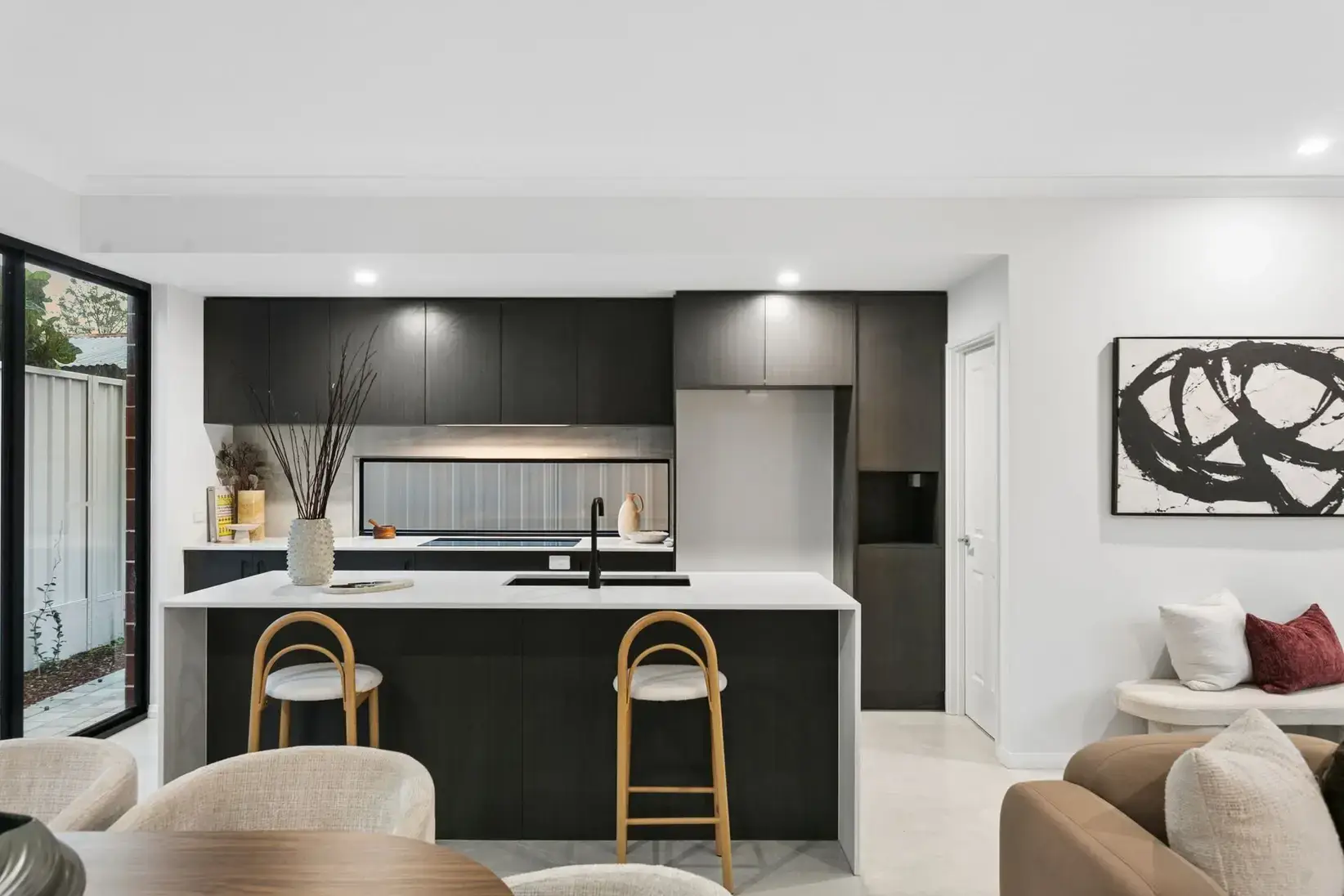 Open-plan kitchen and living area finished by Elemental Construction & Consulting